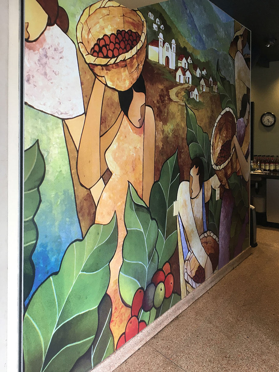 Colorful artist rendition mural in a coffee house cafe depicting coffee being harvested in the fields of Honduras